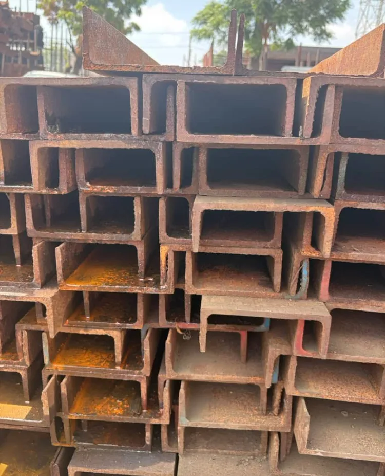 Channel iron stacked outdoors at the yard under open sky.