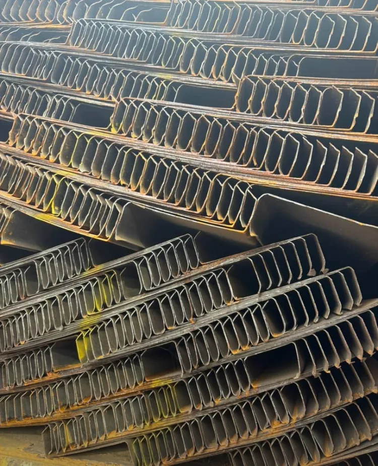 Ridged steel roofing sheet profiles stacked at the yard.