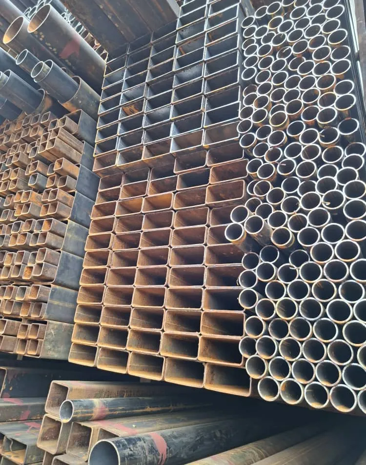 Square hollow tube sections and round pipes stacked side by side.